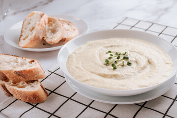 White bowl with mushroom cream soup - healthy food concept. Classic recipe