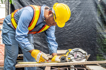 Construction worker are using tape measurements to measure planks and pencil are used to write, Male hands measuring wood flooring, Construction industry, housework do it yourself...