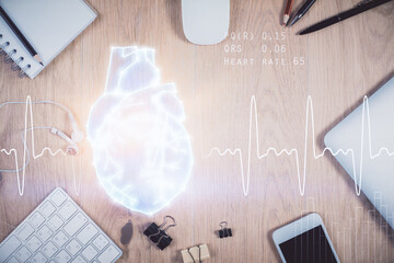 Double exposure of heart drawing over table with phone. Top view. Medical education concept.