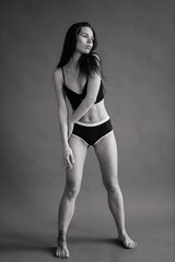 Fototapeta premium Posing fitness seductive woman isolated on grey background