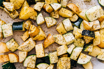 Healthy food background. Less meat concept. Vegetarian food on wooden background. Backing sheet with grilled seasoned vegetables. Lifestyle home cooking