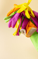 Multicolored working rubber gloves to protect hands while washing close up, cleaning concept