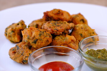 Indian snack pakora with tomato sauce or chutney