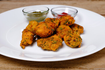 Indian snack pakora with tomato sauce or chutney