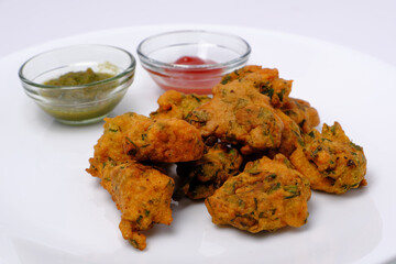 Indian snack pakora with tomato sauce or chutney
