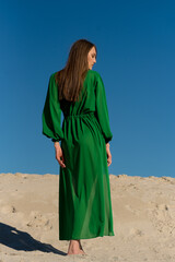 Sexy bikini woman relaxing on beach  pareo cover up green  beachwear 