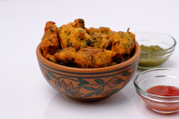Indian snack pakora with tomato sauce or chutney
