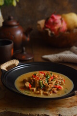 a bowl of tempeh cooked in coconut milk and spices named jangan ndeso in Bahasa