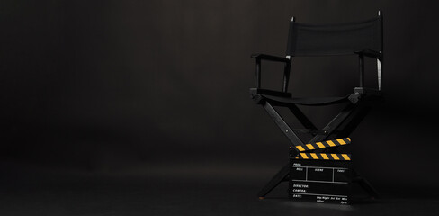 Black director chair and Clapper board or movie Clapperboard on black background.use in video production or film cinema industry