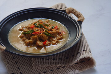 a bowl of tempeh cooked in coconut milk and spices named jangan ndeso in Bahasa