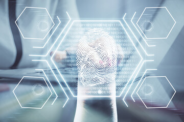 Double exposure of woman hands typing on computer and fingerprint drawing. Security concept.