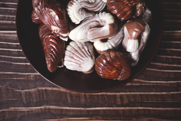 a lot of variety chocolate pralines in a plate.