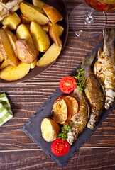 Grilled fish on plate with lemon and vegetables