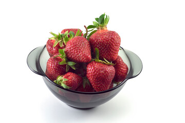 
Strawberries in a black glass plate on a white background.