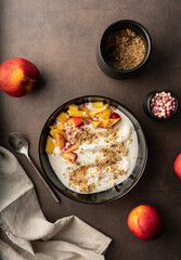 selective focus. morning breakfast. natural yogurt with fruit and added muesli. healthy food. top view, with deep shadows. texture. low key, copyspace