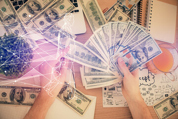 Multi exposure of creative drawing hologram and USA dollars bills and man hands. Start up concept