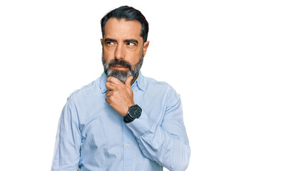 Middle aged man with beard wearing business shirt thinking worried about a question, concerned and...