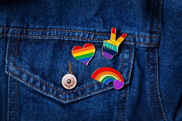 Rainbow lgbtq flag badges against denim background, pride month