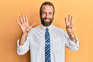 Handsome man with beard and long hair wearing business clothes showing and pointing up with fingers number eight while smiling confident and happy.
