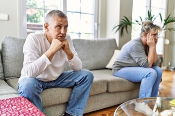 Senior caucasian couple in trouble sitting on the sofa at home.
