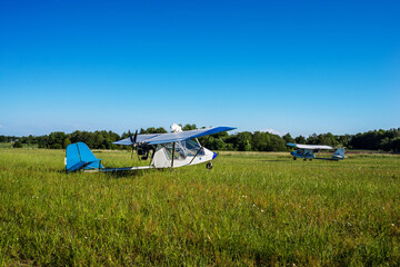 two white light civil aviation aircraft on a moen greenfield