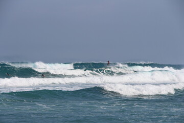 surfers catch high powerful waves of the Atlantic Ocean on the islands of the Caribbean