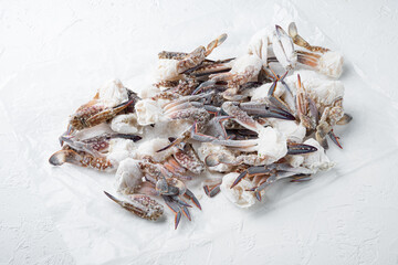 Frozen raw blue swimming crab claws, on white background