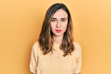 Fototapeta premium Young hispanic girl wearing casual clothes with serious expression on face. simple and natural looking at the camera.