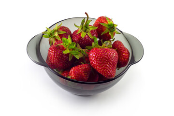 Strawberries in a black glass plate on a white background.