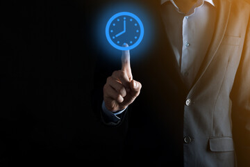 Businessman hand holds the icon of hours clock with arrow. Rapid execution of the work.Business time management and business time is money concepts