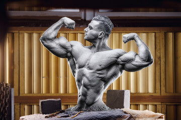 Athletic bodybuilder statue on the sculptor's desk