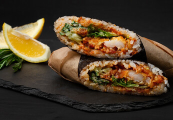  Sushi burrito , sushirrito, with shrimp rice, spice sauce, cucummber, lettuce, nori, on a black  background, 