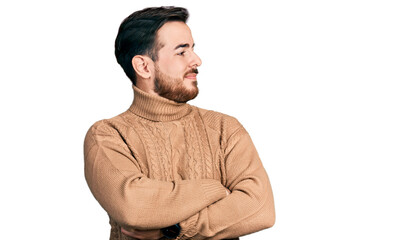 Young hispanic man wearing casual clothes looking to the side with arms crossed convinced and confident