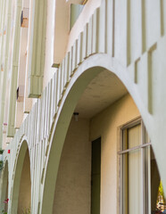 Large arches at the entrance to a building in a historic downtown area. 