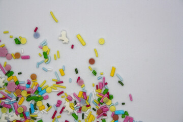 Confectionery multicolored sprinkles on a white background.