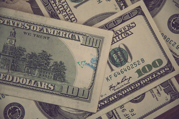 Flat lay American cash banknotes 100 dollar bills marked by inked symbols. Blue ink strange symbols stamped on banknote. Cash US dollar money background