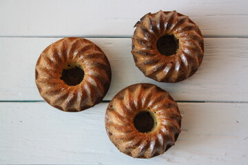 A small shaped cupcake on a wooden board.