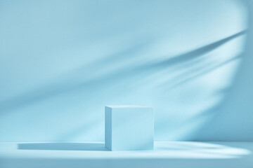 Blue background for product presentation with shadows and light. Empty cubic podium. Mockup.