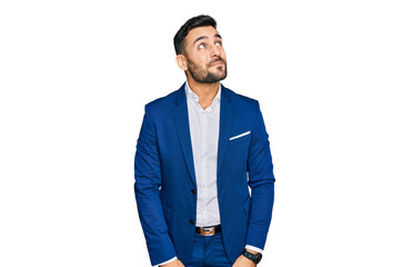 Young hispanic man wearing business jacket smiling looking to the side and staring away thinking.