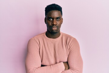 Obraz premium Handsome black man wearing casual clothes skeptic and nervous, disapproving expression on face with crossed arms. negative person.