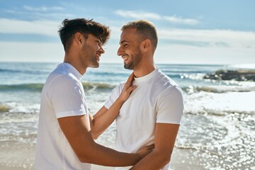 Romantic young gay couple at the beach.