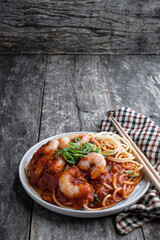 Stir fry noodles with shrimps and vegetables on wooden table
