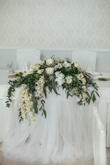 Wedding flower arrangement for the newlyweds' table of white roses