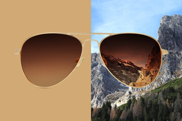 aviator sunglasses isolated on brown and winter background with snow on the mountain tops, concept...