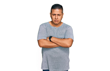 Young latin man wearing casual clothes skeptic and nervous, disapproving expression on face with crossed arms. negative person.