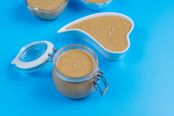 Homemade peanut butter in a jar and bowl.