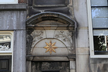 Fototapeta na wymiar Amsterdam Keizersgracht Canal Building Facade Detail Depicting a Golden Star