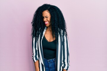 Middle age african american woman wearing casual clothes winking looking at the camera with sexy expression, cheerful and happy face.