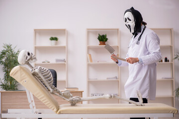 Devil doctor examining skeleton patient