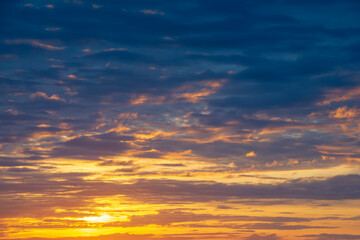 Sunrise in cloudy sky over the sea